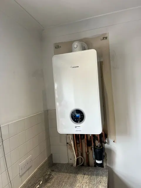 New wall-hung gas combi boiler installed by Gas Safe registered engineers with neat pipework in a tiled utility area.