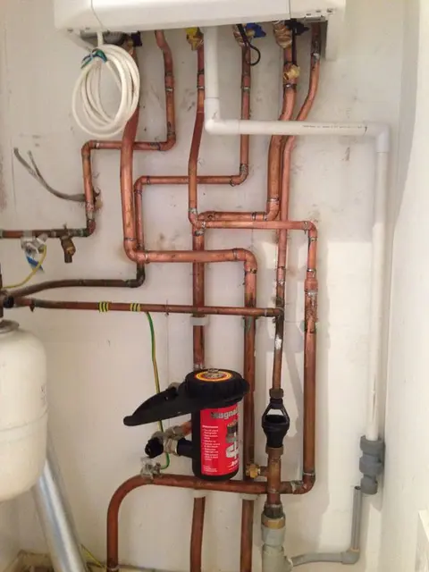 Neatly soldered copper central heating manifold pipework with automatic air vent installed by our heating engineers.