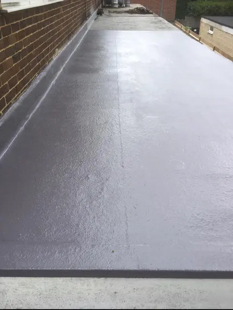 Completed GRP fibreglass flat roof with upstands and trims on a London extension.